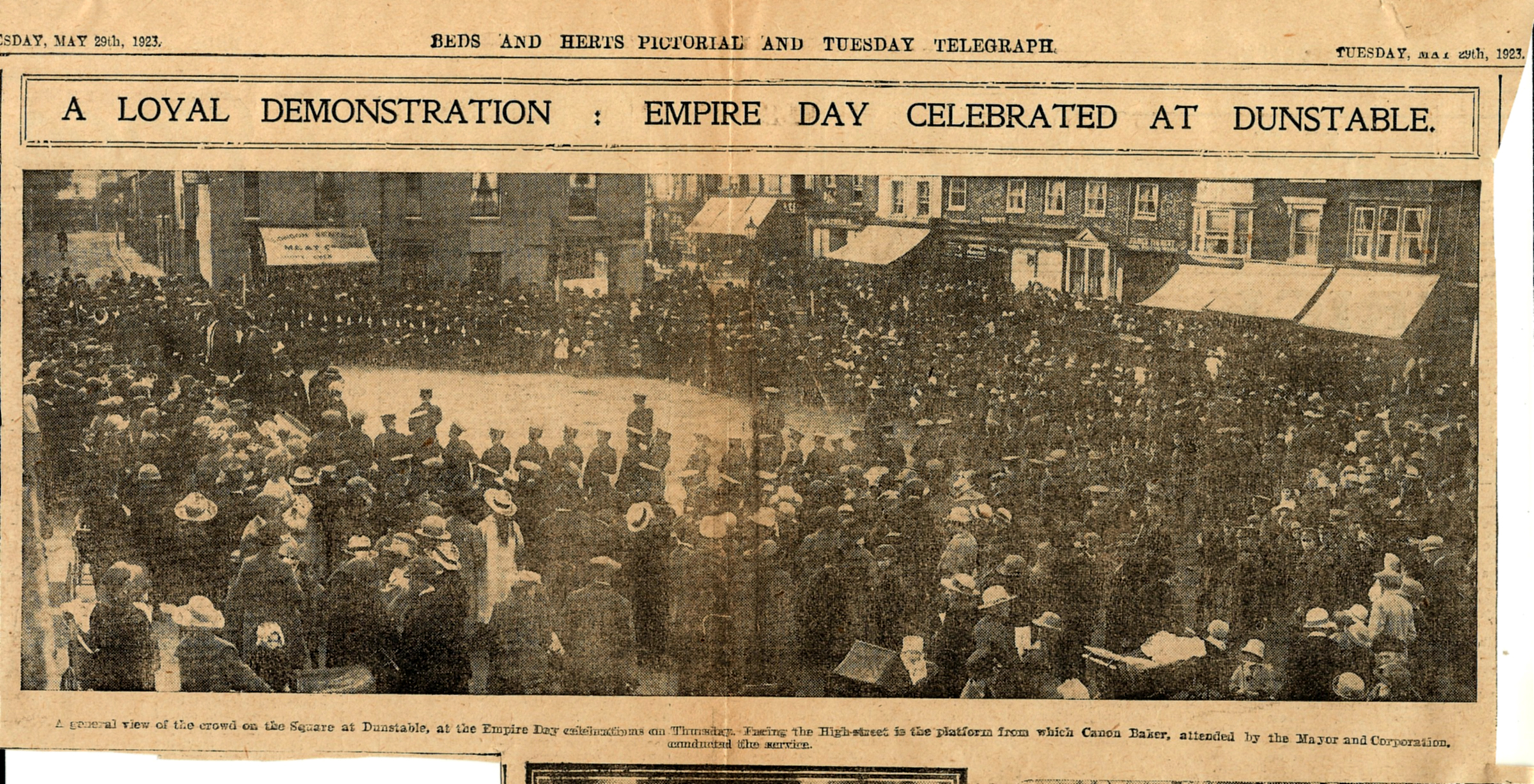 Newspaper cutting of empire day taking place in the square, large crowd.